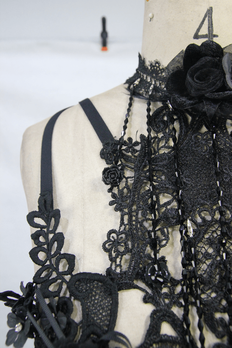 Close-up of a women's gothic lace harness with 3D flowers and black straps, showcasing elegance and allure.