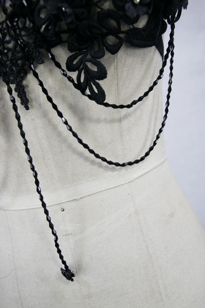 Close-up of women's gothic lace harness with 3D flowers and detachable glass diamonds, highlighted on a mannequin.