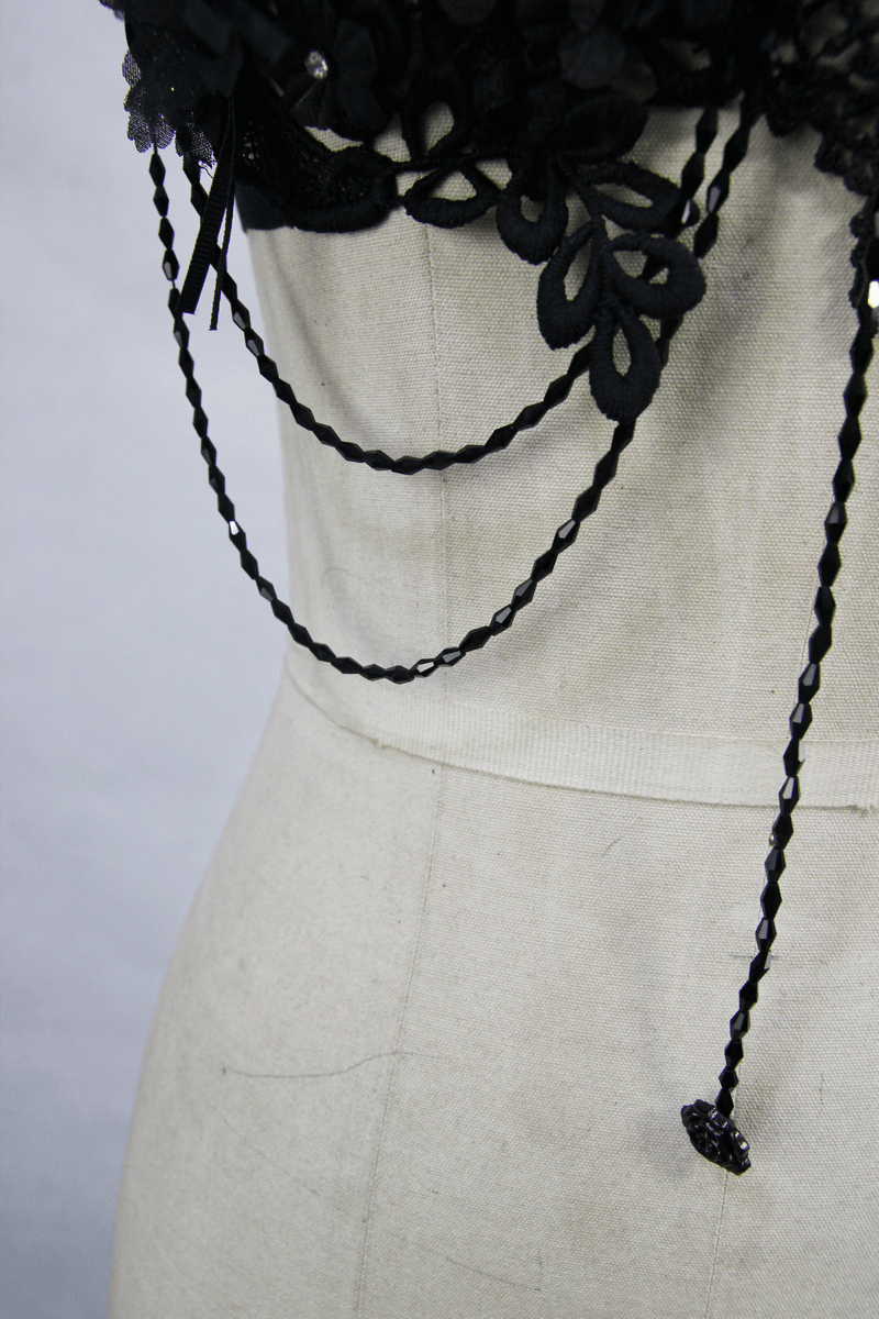 Close-up of women's gothic lace harness with intricate 3D flowers and decorative chains showcasing elegant details.