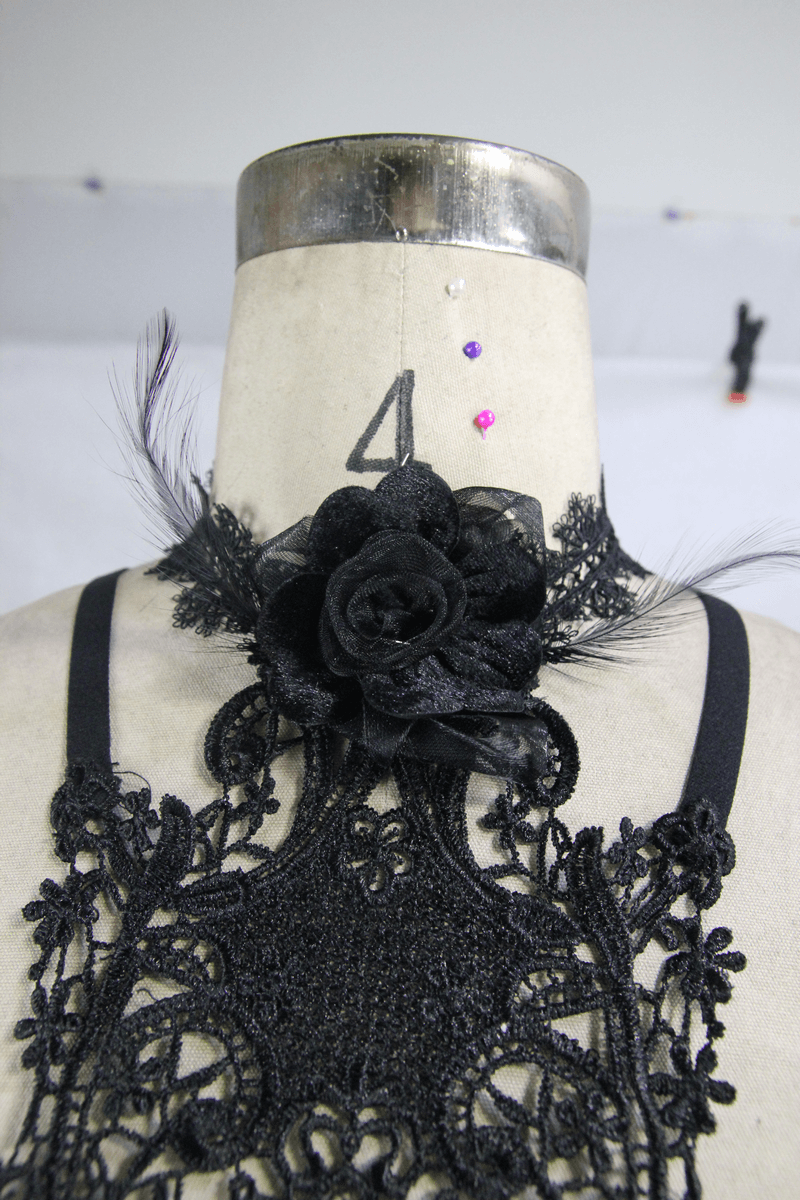 Close-up of women's gothic lace harness with black 3D flower and delicate lace details.