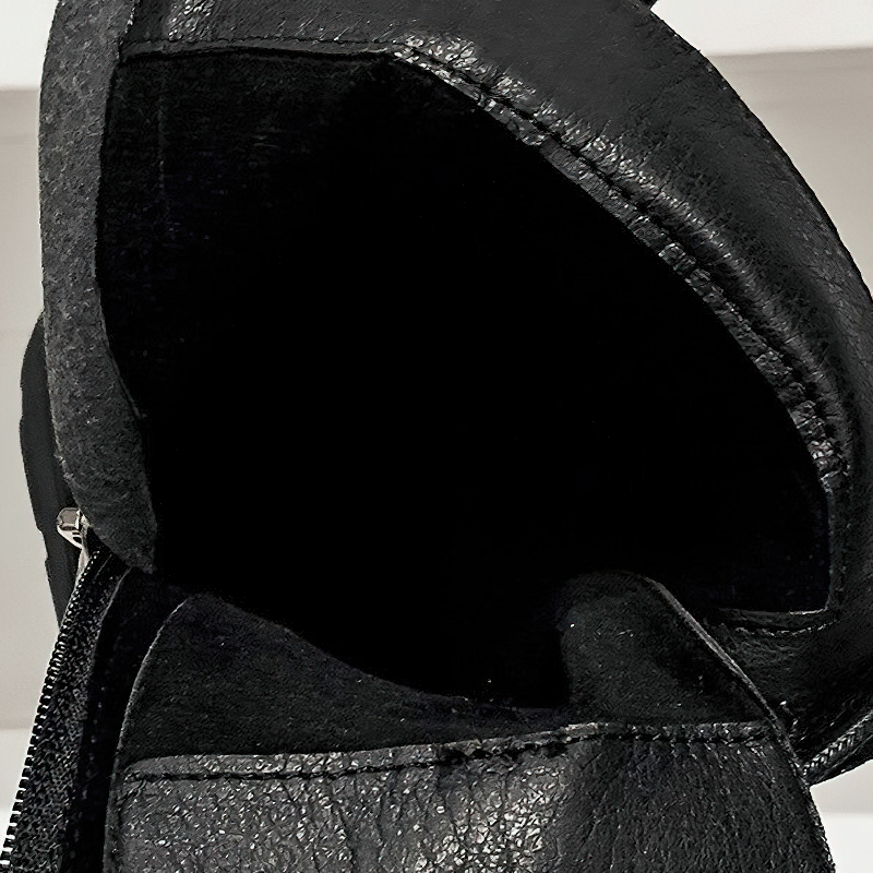 Interior view of a black lace-up ankle motorcycle boot, showcasing soft lining and zipper detail for style and comfort.