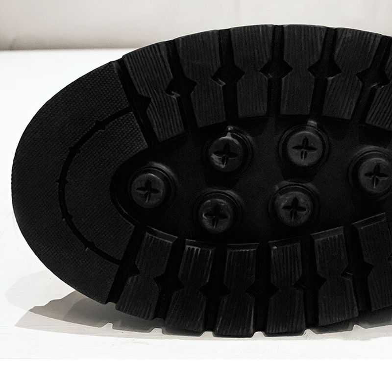 Close-up of the rugged sole of women's lace-up ankle motorcycle boots, showing traction and durability features.