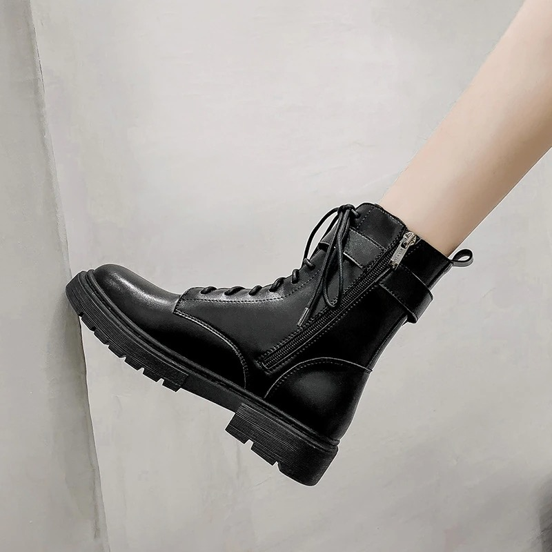 Stylish women's lace-up black ankle motorcycle boots with a buckle and side zipper, perfect for a gothic fashion statement.
