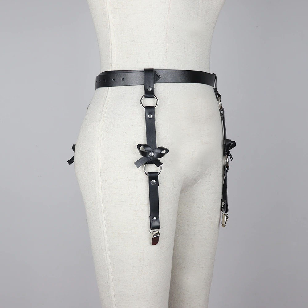 Women's leather BDSM body harness with adjustable belts and gothic style design on display.