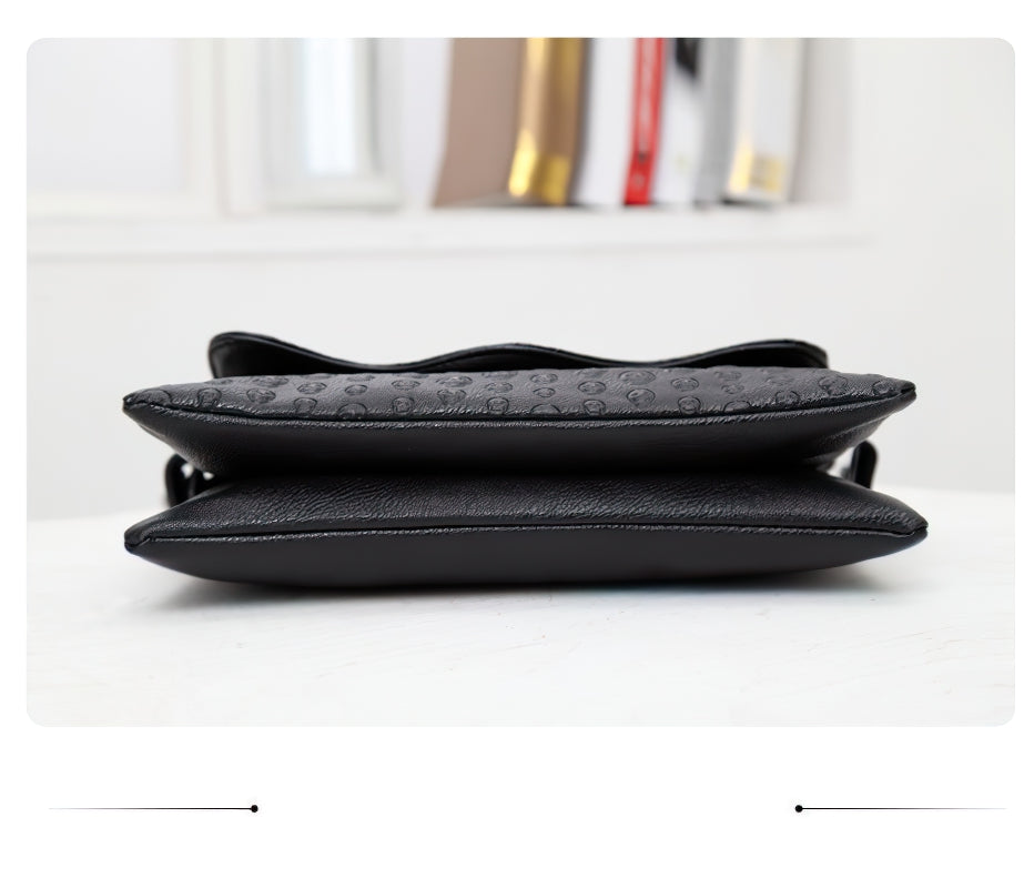 Women's leather gothic shoulder bag with skull details, showcasing its stylish side view.