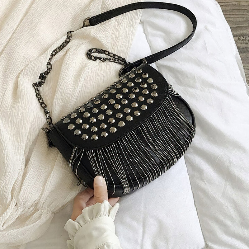 Elegant women's leather shoulder bag with diamond-like rivets and chains, perfect for casual outfits.