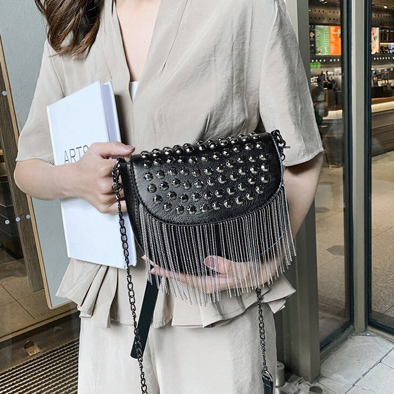Stylish women's leather shoulder bag with rivets and chains, featuring a chic fringe design for casual elegance.