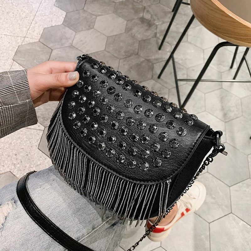 Stylish women's leather shoulder bag with diamond decorations and fringe, perfect for a casual look.