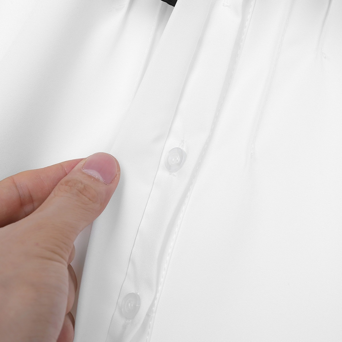 Close-up of women's white long sleeve button-up shirt showcasing turn-down collar and button details.