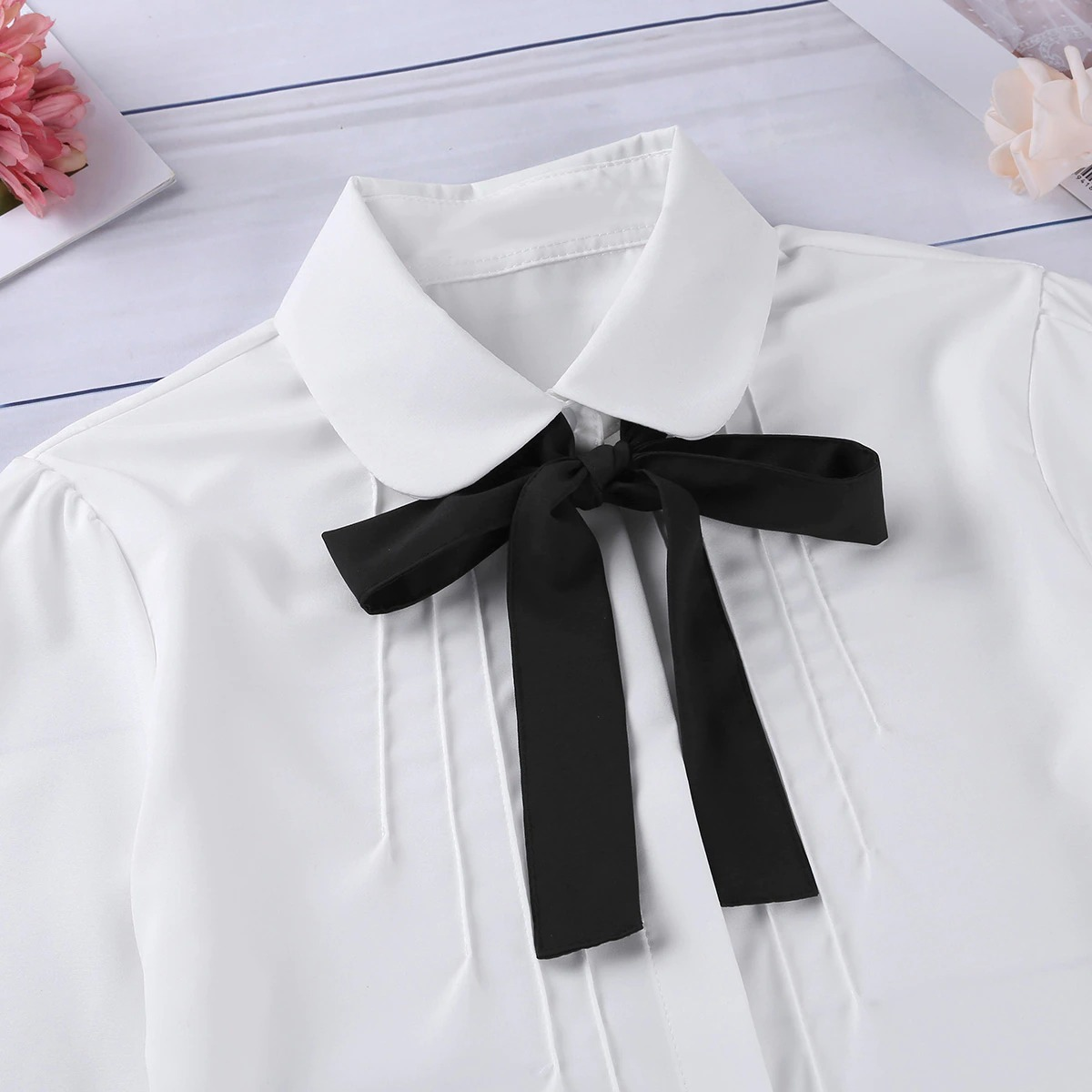 Women's white blouse with turn-down collar and black detachable bowknot, perfect for casual and formal outfits.
