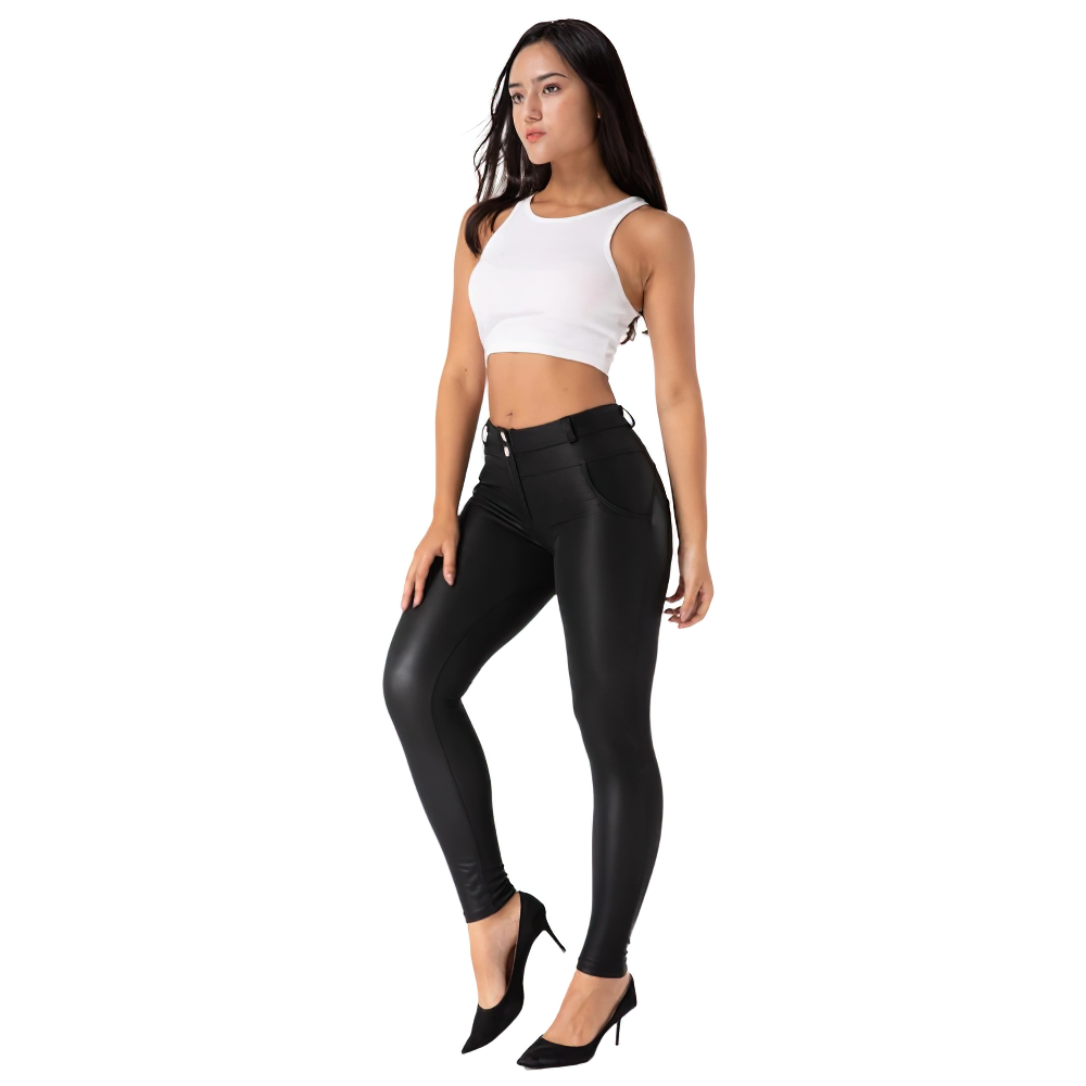 Woman in white crop top and skinny matte black PU leather pants, embodying alternative fashion style.