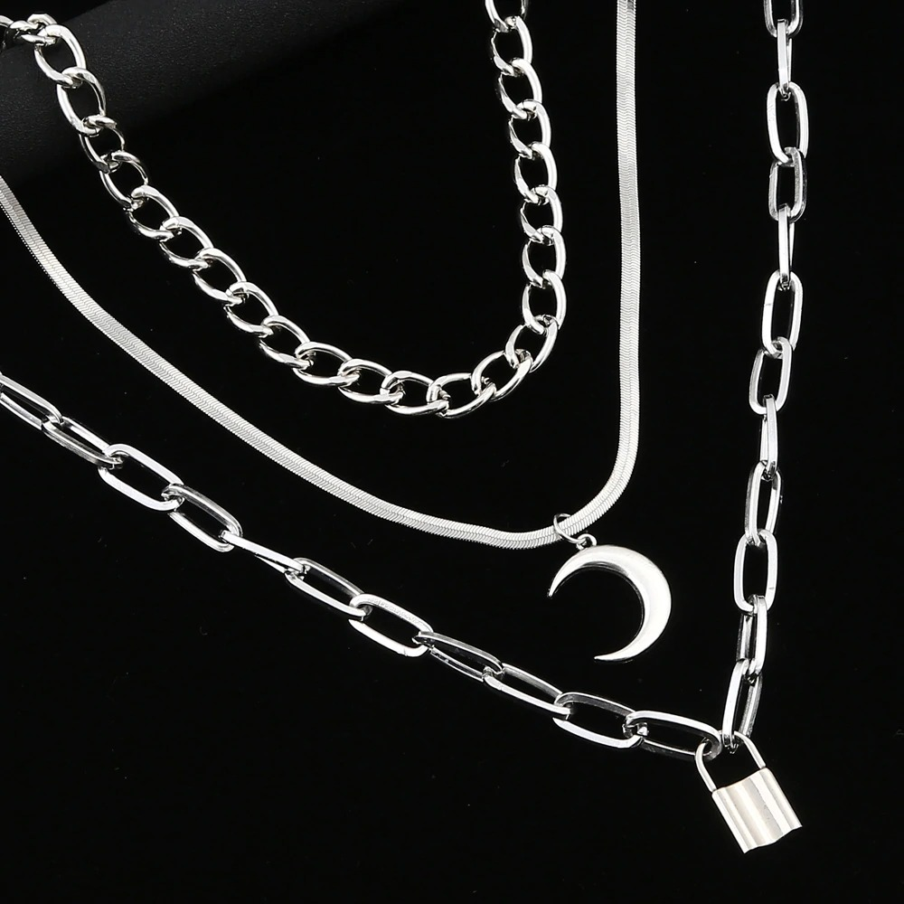 Trendy layered silver chain necklace with moon and lock pendant, perfect for gothic style outfits.
