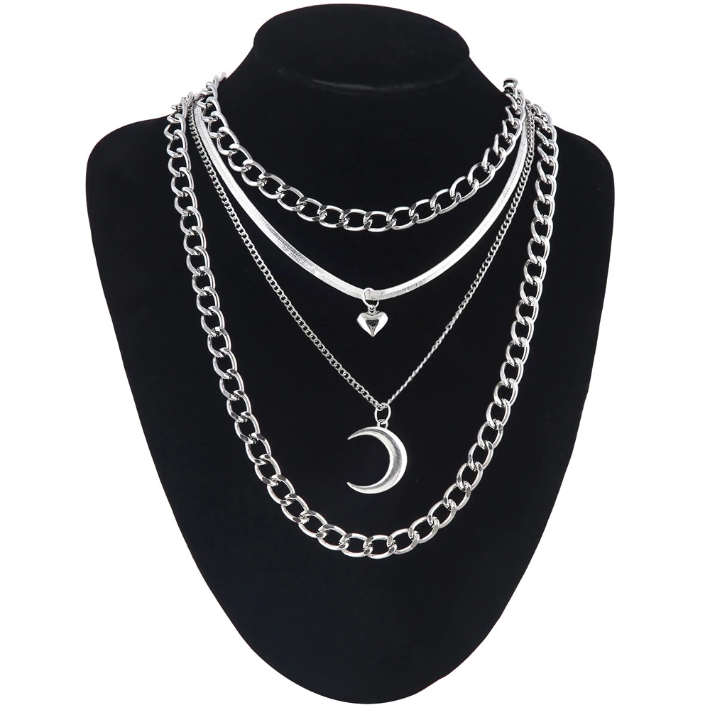 Layered silver chain necklace featuring moon and heart pendants for trendy fashion.