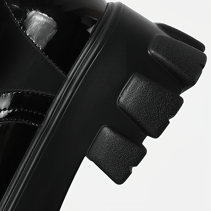 Close-up of women's black platform motorcycle boot featuring a sleek design and textured sole.