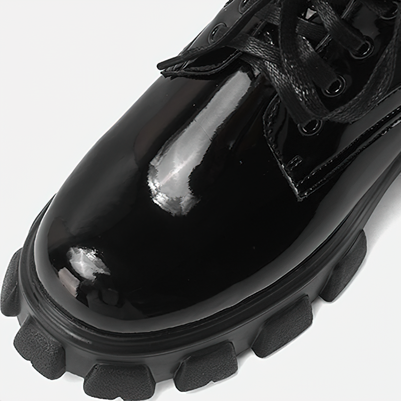 Close-up of Women's Motorcycle Platform Black Boots, showcasing sleek black leather and bold chunky sole.