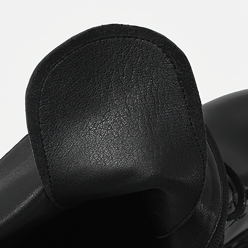Close-up of the black leather heel of women's motorcycle boots with pockets, showcasing its sleek design.