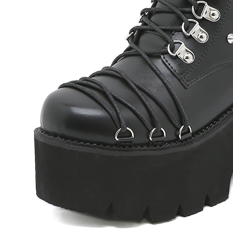 Close-up of women's punk style motorcycle platform boots with lace-up detail and chunky heel.