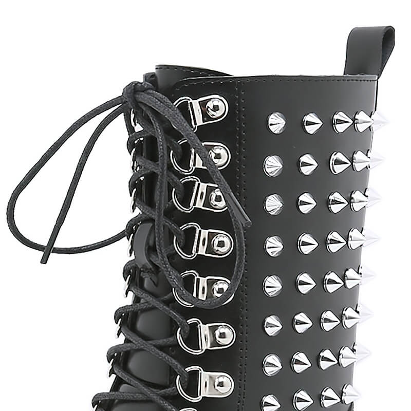 Close-up of women's punk-style motorcycle platform boots with silver rivets and laces, showcasing a bold fashion statement.