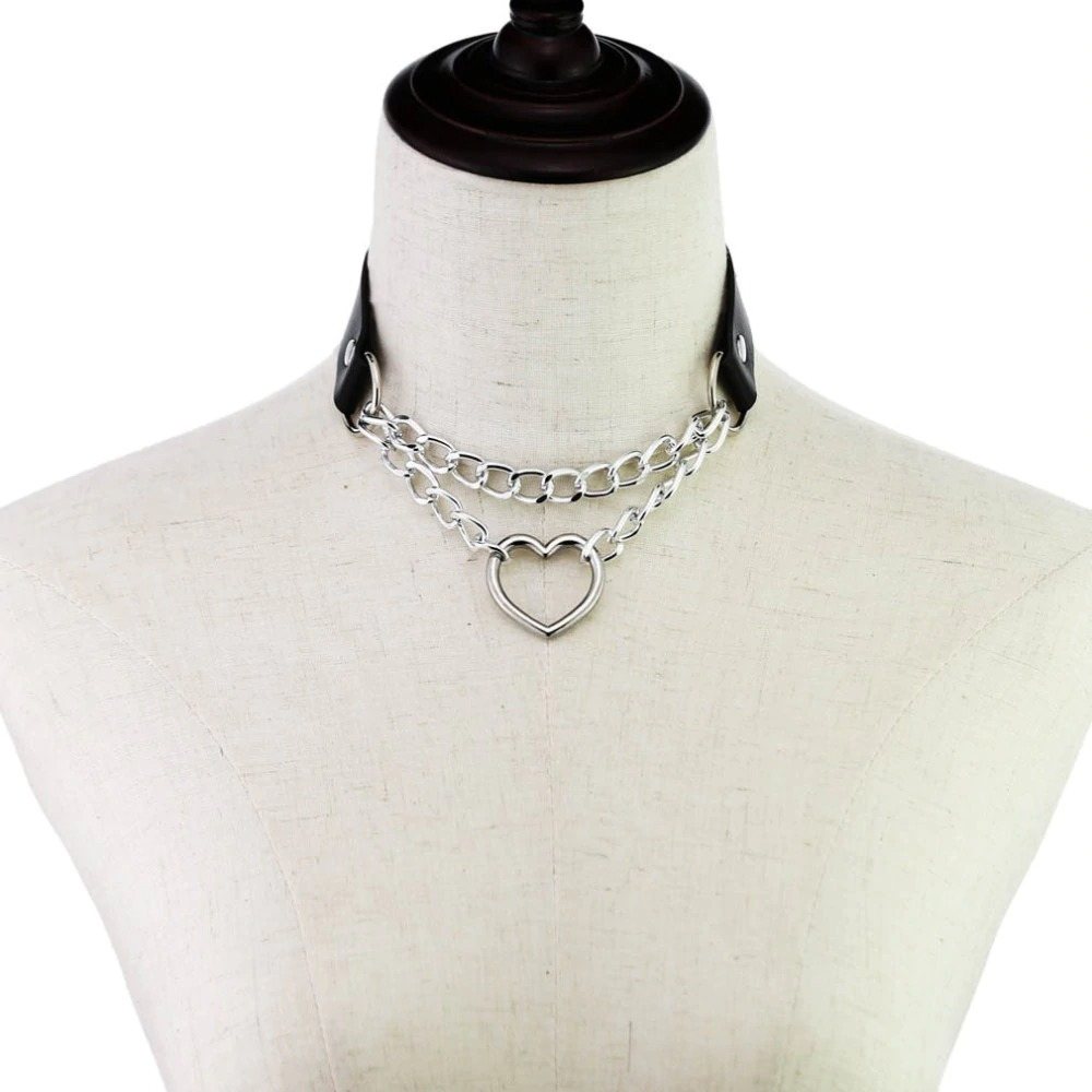 Punk style women's choker necklace with heart pendant and metal chains on a display mannequin.