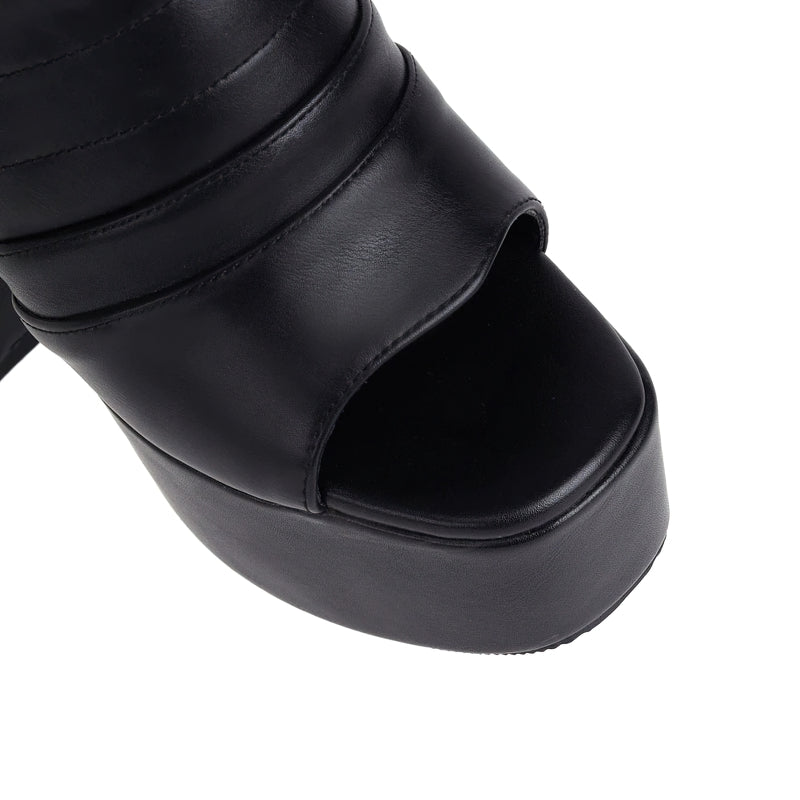 Close-up of stylish black women's open toe platform shoes with high square heel, featuring trendy PU leather design.