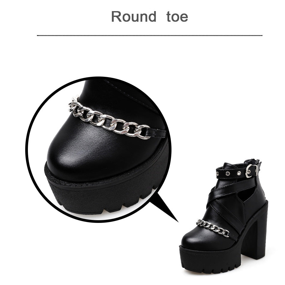 Close-up of women's gothic platform ankle boots with chain, featuring a round toe and thick rubber heel.