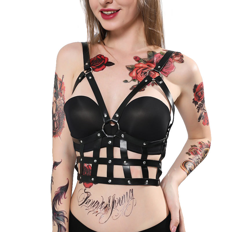 Edgy women's PU leather black body harness with adjustable straps, showcasing punk style and bold fashion.