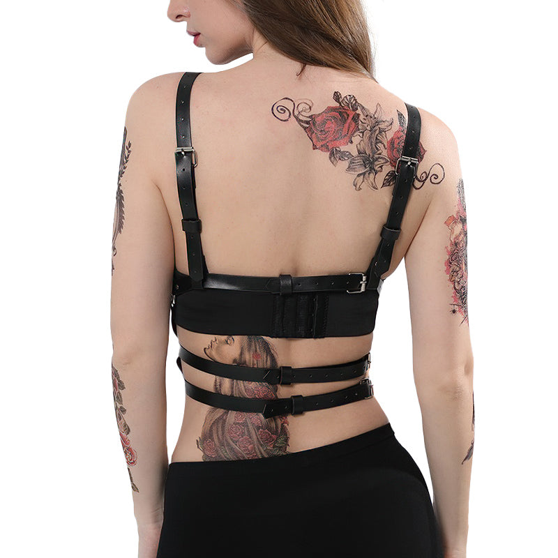 Back view of women's PU leather body harness with adjustable straps and tattoos.