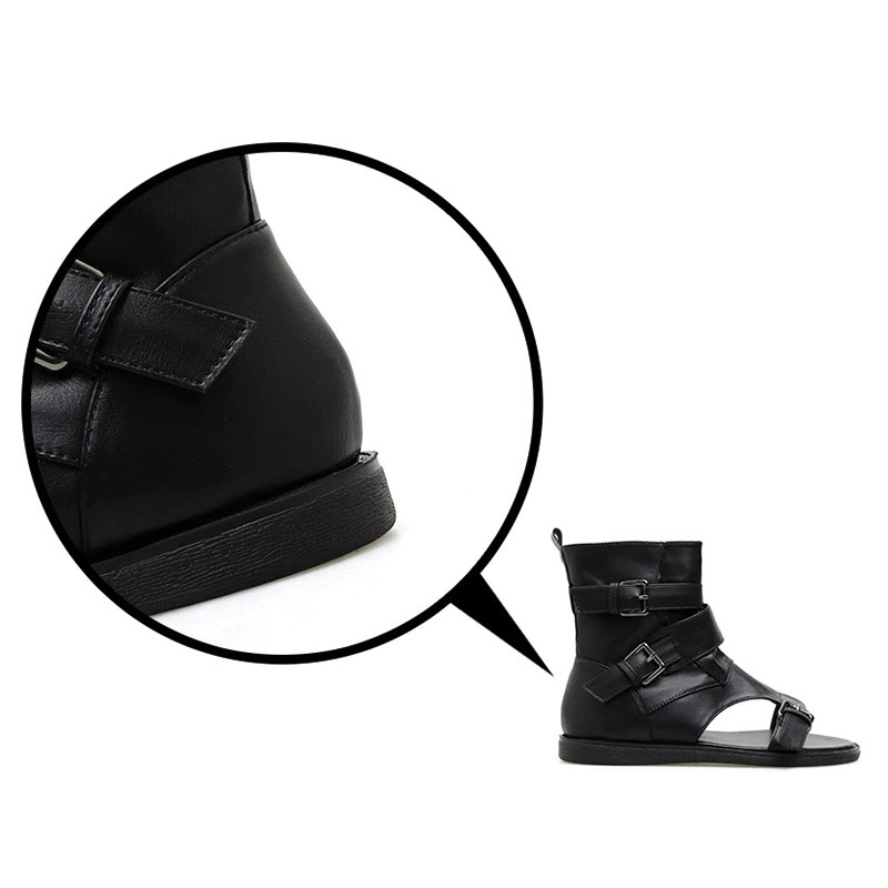 Close-up of women's black PU leather gladiator sandals with buckles, showcasing Gothic alternative fashion style.