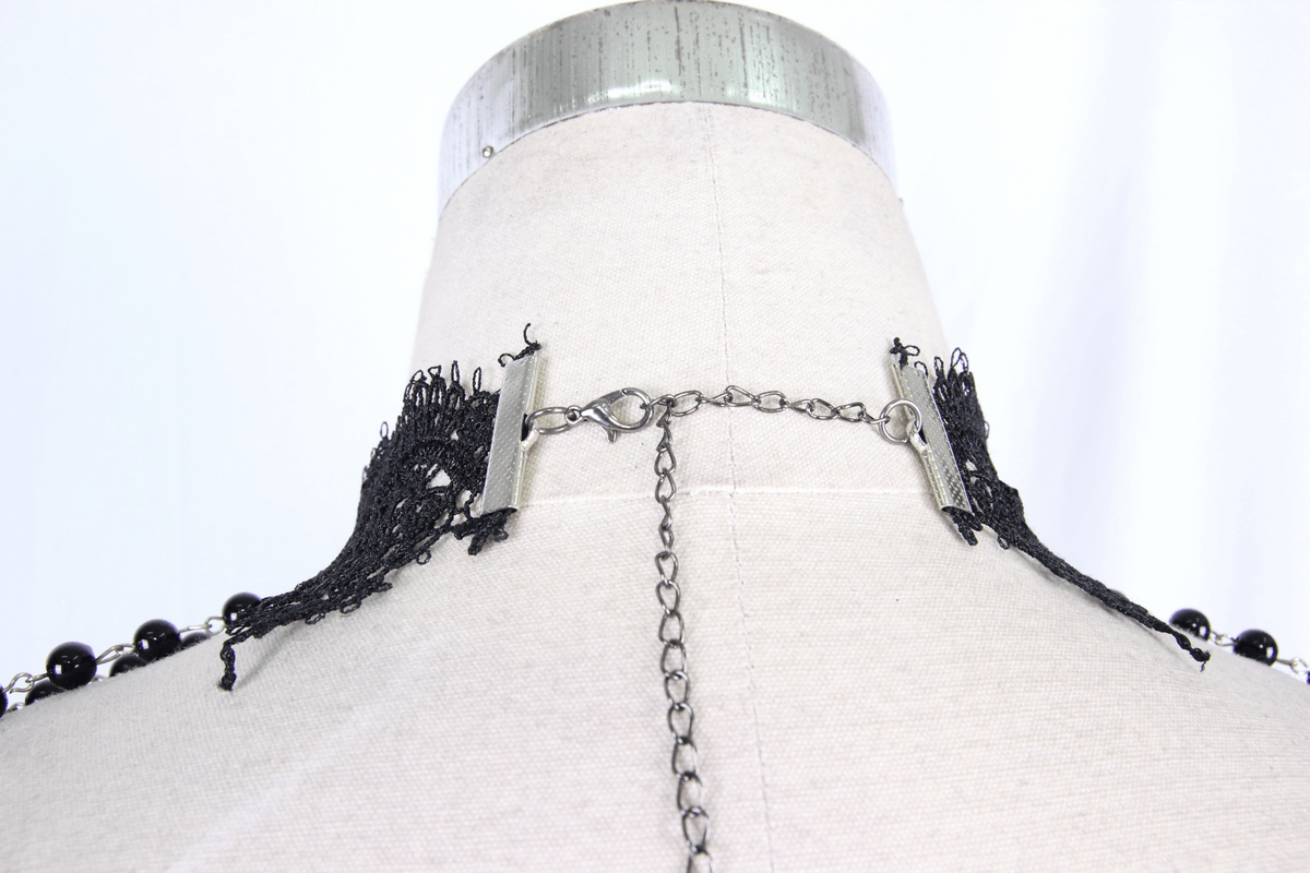 Close-up of women's punk beaded necklace showing black beads and intricate lace detail on the back.