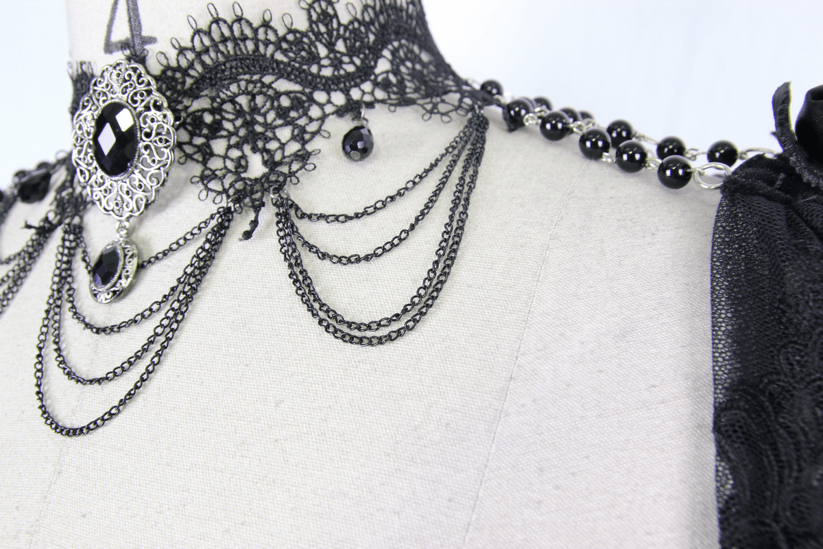 Close-up of a women's punk beaded necklace with lace and chains, showcasing vintage black beads and an elegant pendant.
