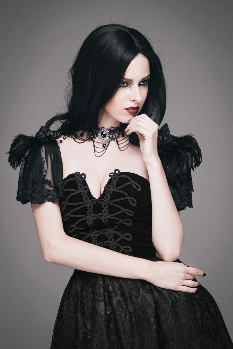 Elegant woman in black dress showcasing a punk style beaded necklace with shawl sleeves and vintage flair.