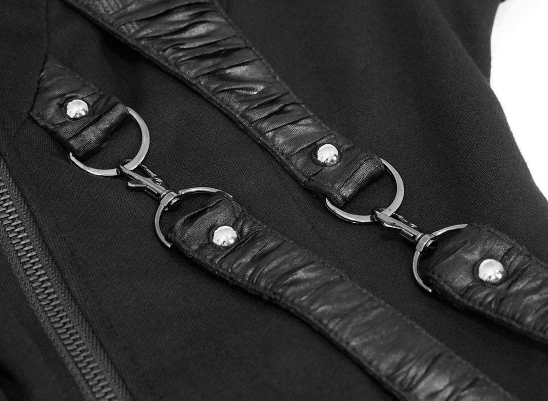 Close-up of black asymmetrical coat showcasing unique zippers and textured inserts for a stylish gothic look.