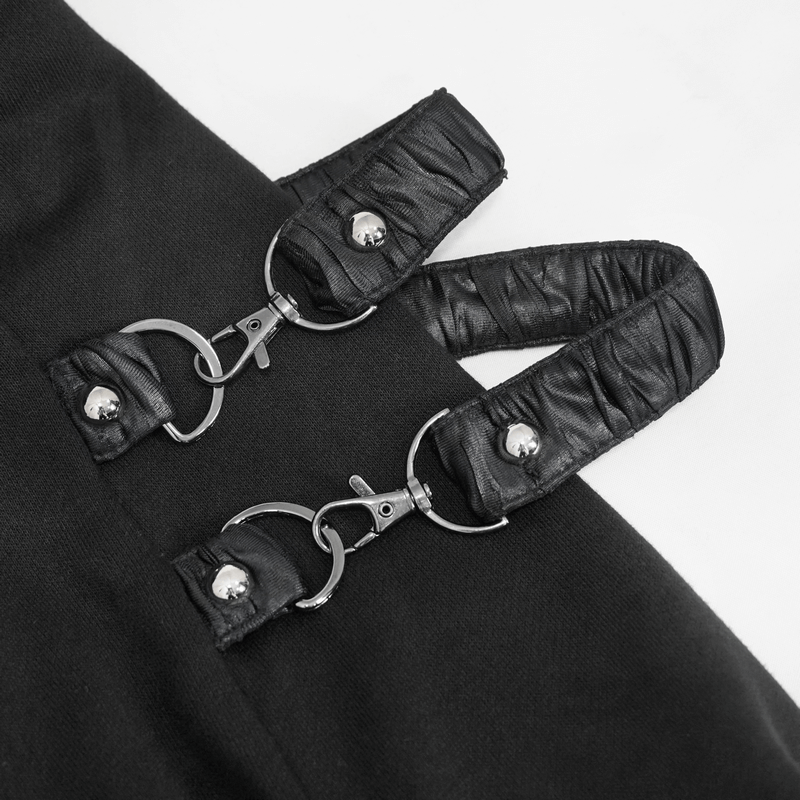 Close-up of unique black leather straps with clips on a women's punk hooded coat, showcasing stylish gothic design.