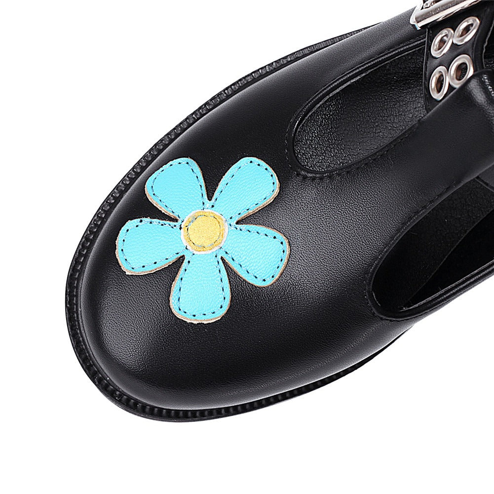 Black women's platform shoe with colorful flower design, showcasing punk style and fun fashion elements.
