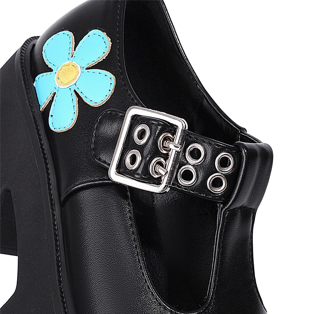 Close-up of women's black platform pump with blue flower design and buckles, perfect for punk-inspired style.