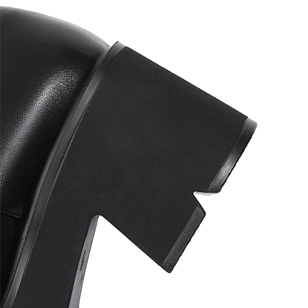 Close-up of a black chunky square heel of women's punk style platform pumps with a unique cut.
