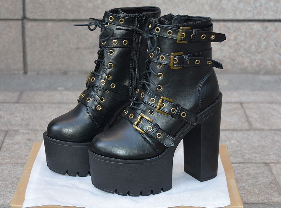 Women's black rivet platform boots with thick heels and stylish buckles, perfect for gothic outfits.