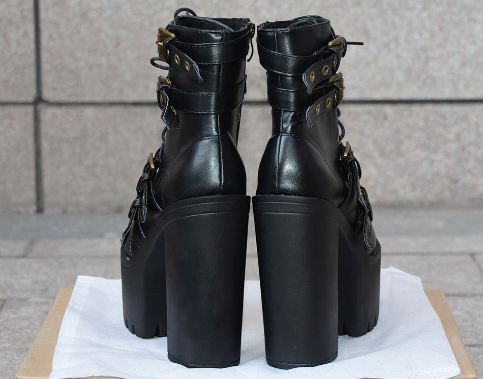 Back view of women's black rivet platform boots with thick heels and buckles, perfect for gothic outfits.