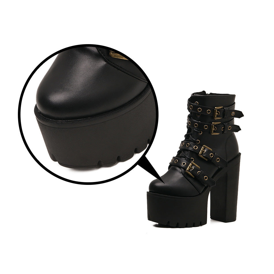Close-up of black Gothic platform boots with rivets and thick heel showcasing stylish design and detail.