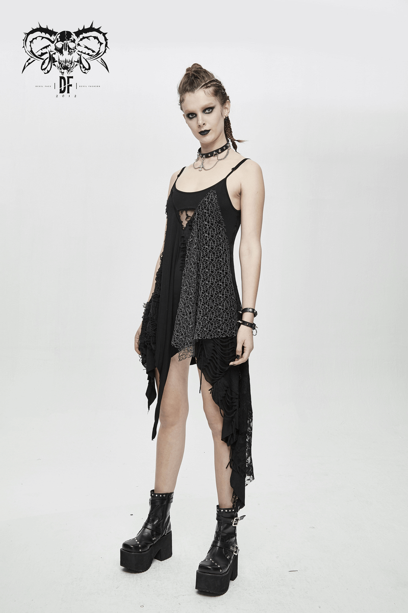 Gothic women's dress with asymmetrical cut, black and ripped details, styled with chunky platform boots.