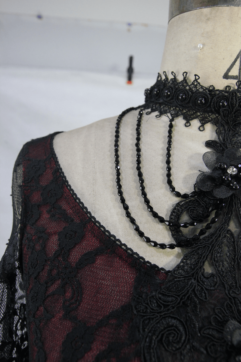 Elegant black lace crop top with intricate beaded neckline and vintage floral details.