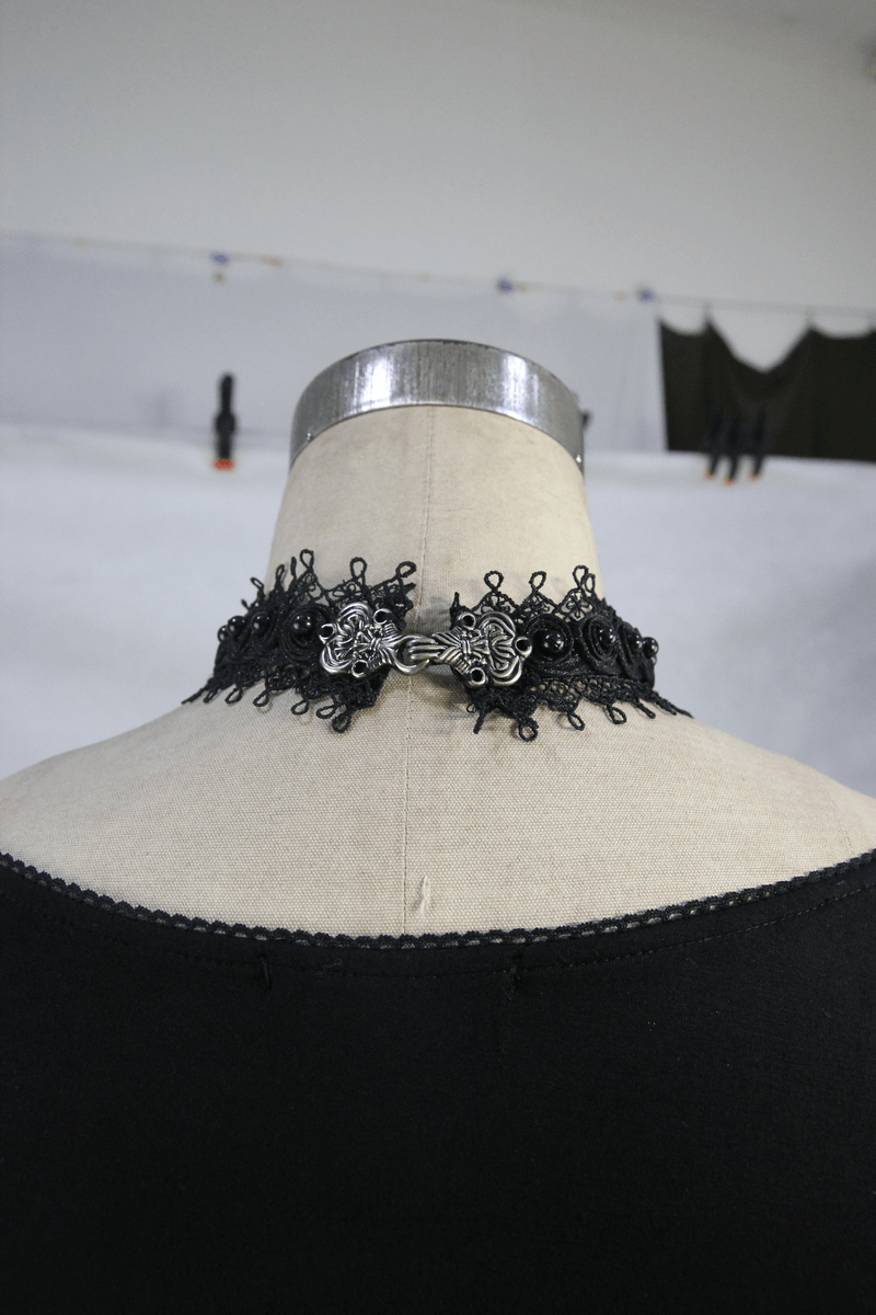 Elegant black lace choker with intricate detailing displayed on a mannequin's neck.
