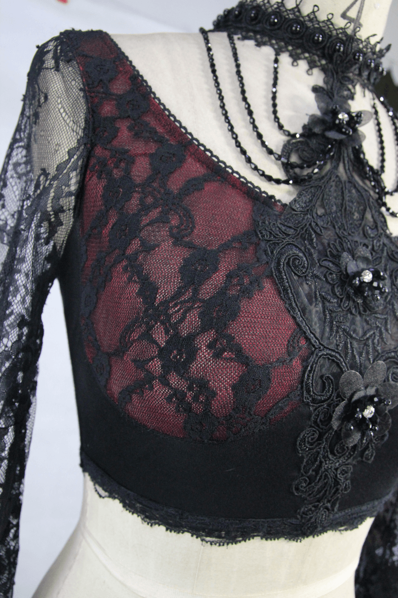 Elegant women's black lace crop top with long lace sleeves and intricate floral details, perfect for gothic fashion lovers.