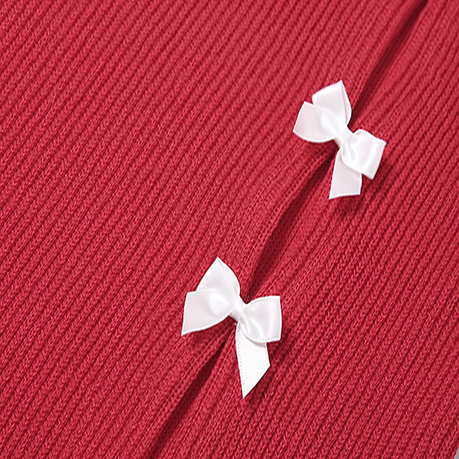 Close-up of a textured red fabric with two white satin bows, highlighting stylish details for a women's dress.