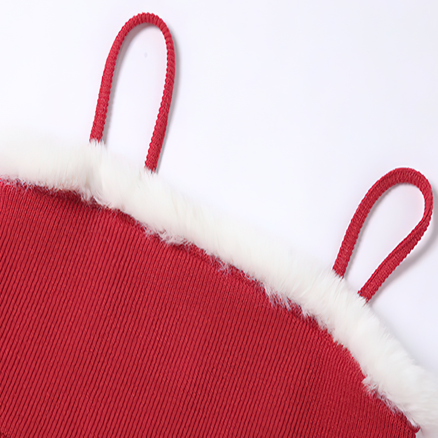 Close-up of red sleeveless Christmas dress with soft white fur trim and adjustable straps, perfect for festive occasions.