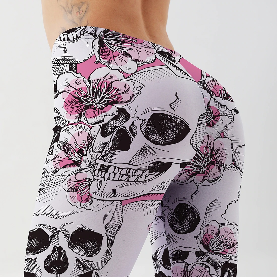 Gothic women's skull print leggings featuring vibrant floral designs for a stylish, edgy look.