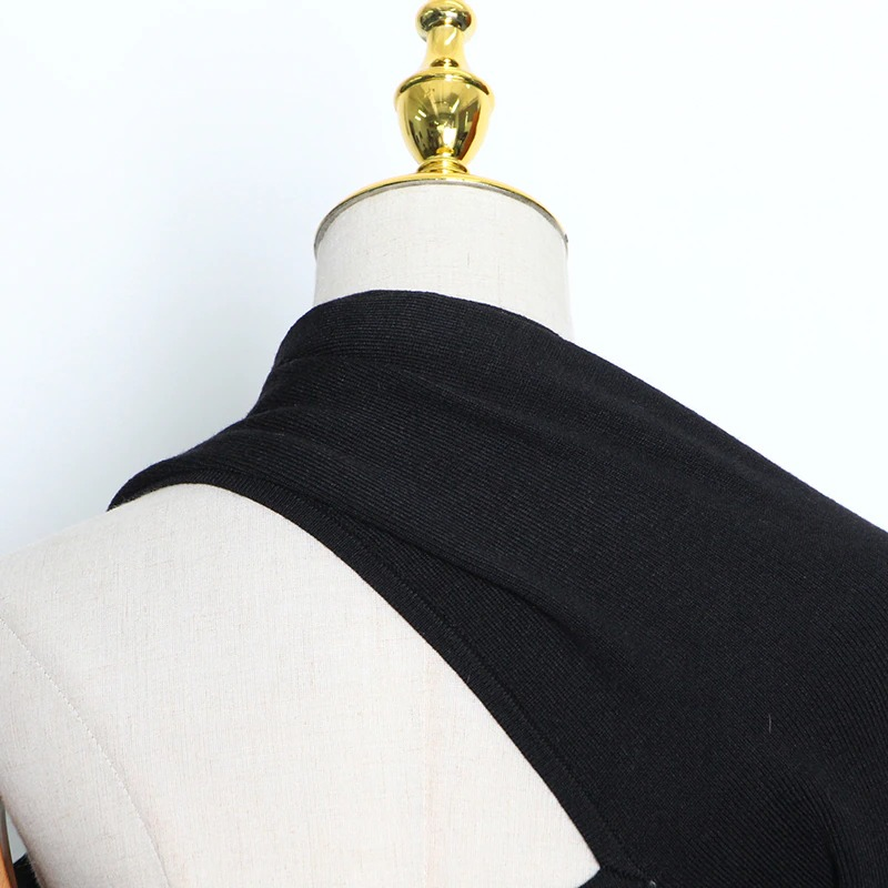 Close-up of black women's slim top with one off-shoulder design, showcasing stylish alternative fashion.