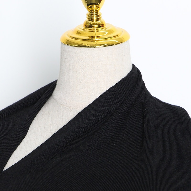 Close-up of black women's slim top with one off-shoulder design, showcasing stylish hollow-out elements.