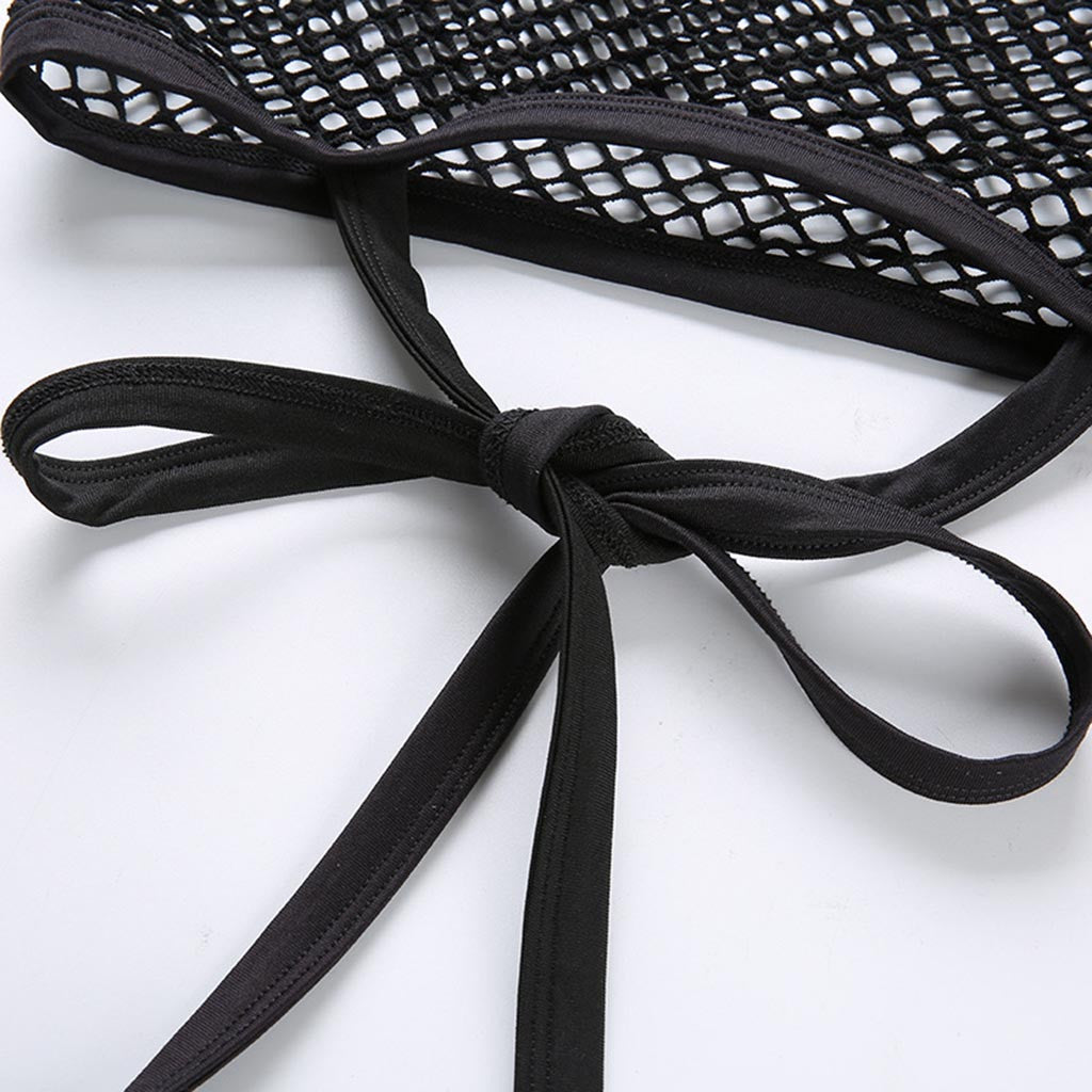 Close-up of black mesh crop top with tied ribbons, showcasing gothic style and unique design details.