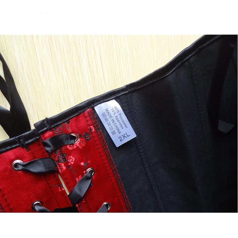 Close-up of a women's red corset with black laces and floral print, size label showing 2XL.